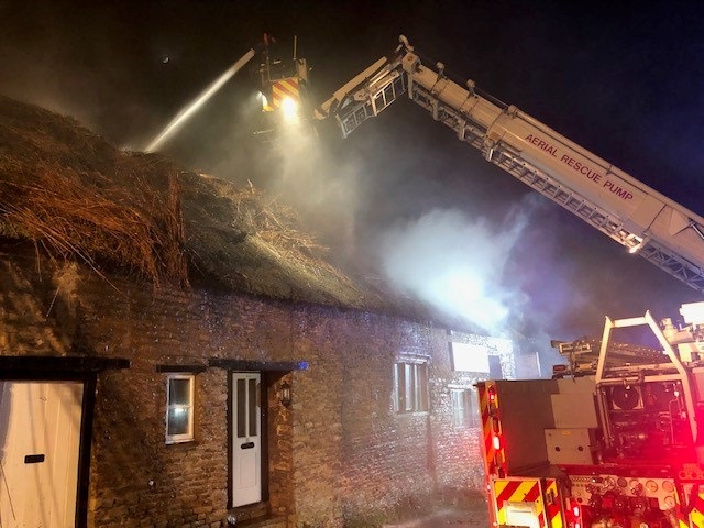 Thatched cottage on fire in Bulwick