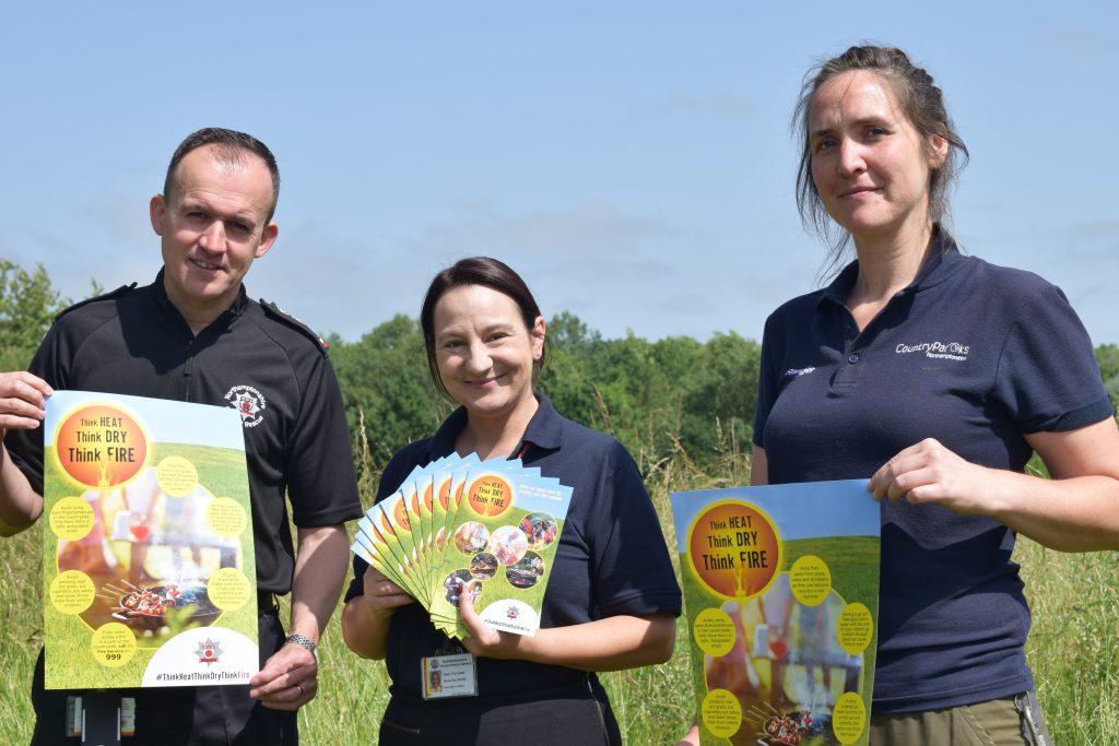 Steve Swan and Tina Collett from Northamptonshire Fire and Rescue Service photographed with Debbie Samwell, a parks ranger, launching the Summer Fire Safety Campaign