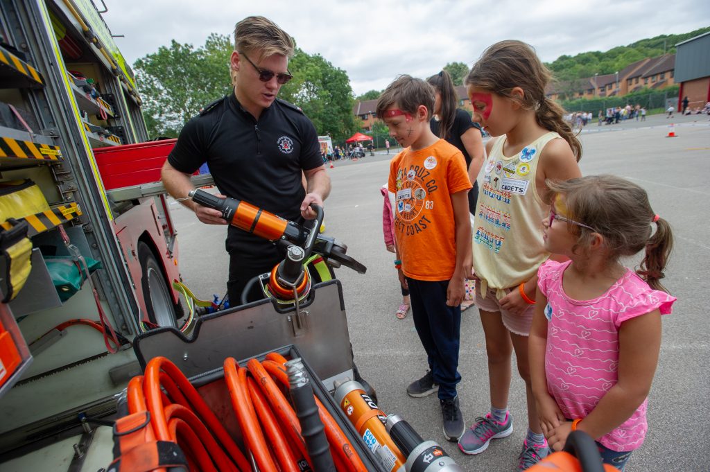 Firefighter shows some visiting children around the contents of a fire engine at last year's fun day