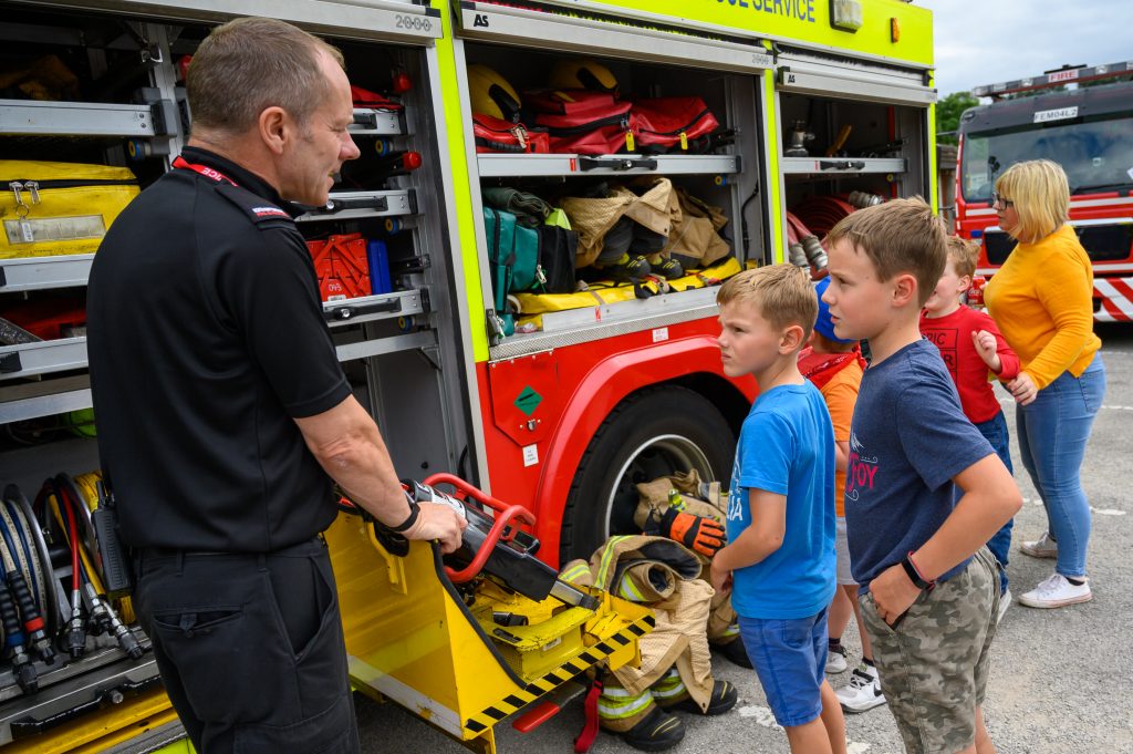 A firefighter leads a tour of one of the fire engines