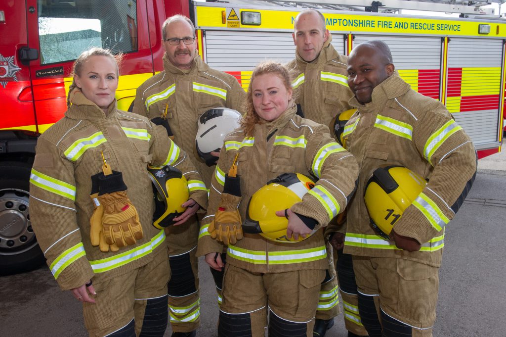 Five firefighters in front of appliance