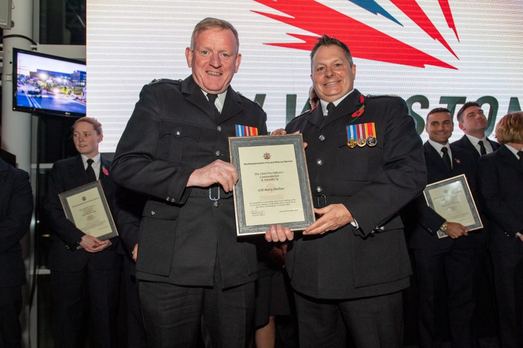 Group Manager Barry Mullan was among the group of Northamptonshire Fire and Rescue Service and East Midlands Ambulance Service staff commended for saving two people from a house fire in Northampton. Pictured with Chief Fire Officer Darren Dovey