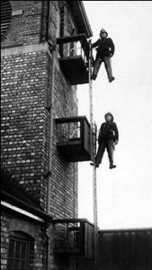 Historical firefighters on a ladder
