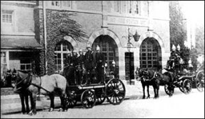 Firefighters with horse drawn carriages