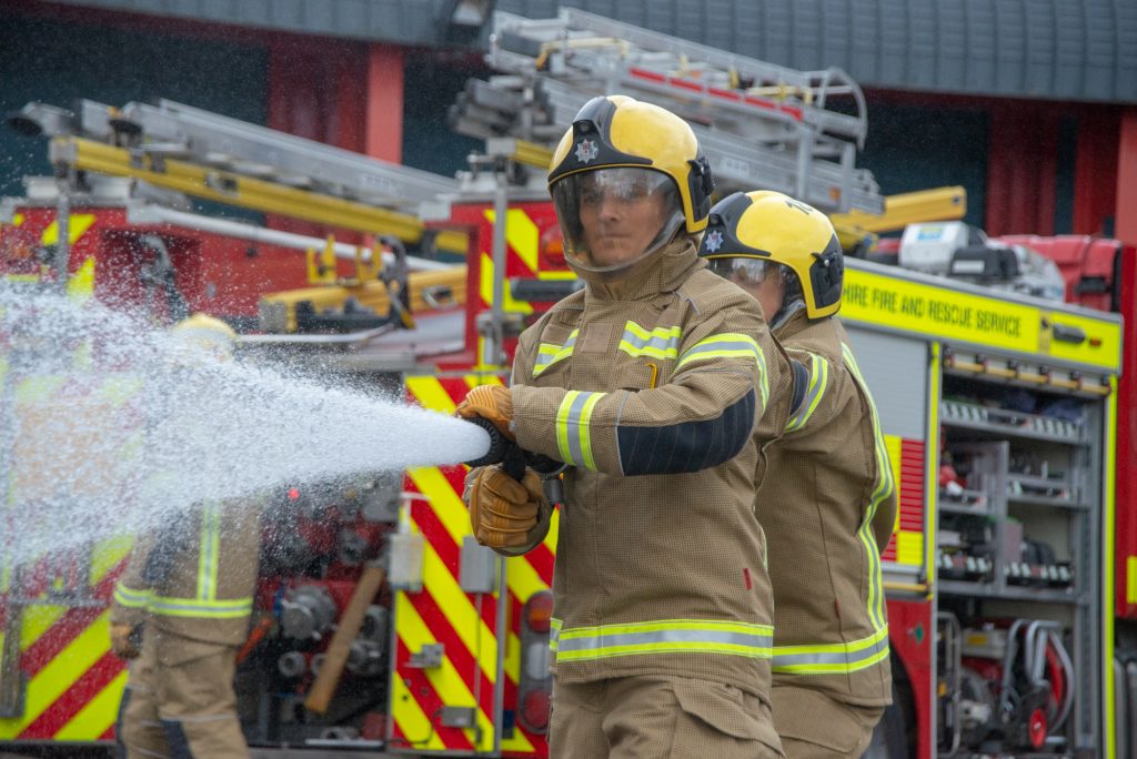 Firefighter using hose