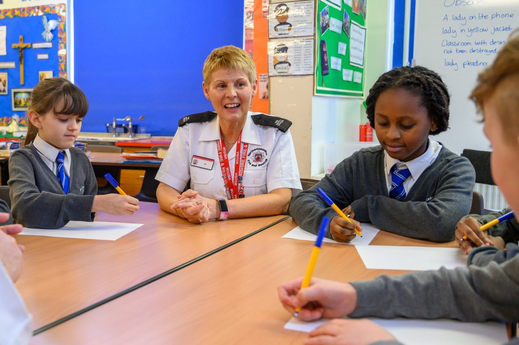 Community Safety Officer Jo Gouldson with children at Our Lady's school in Wellingborough