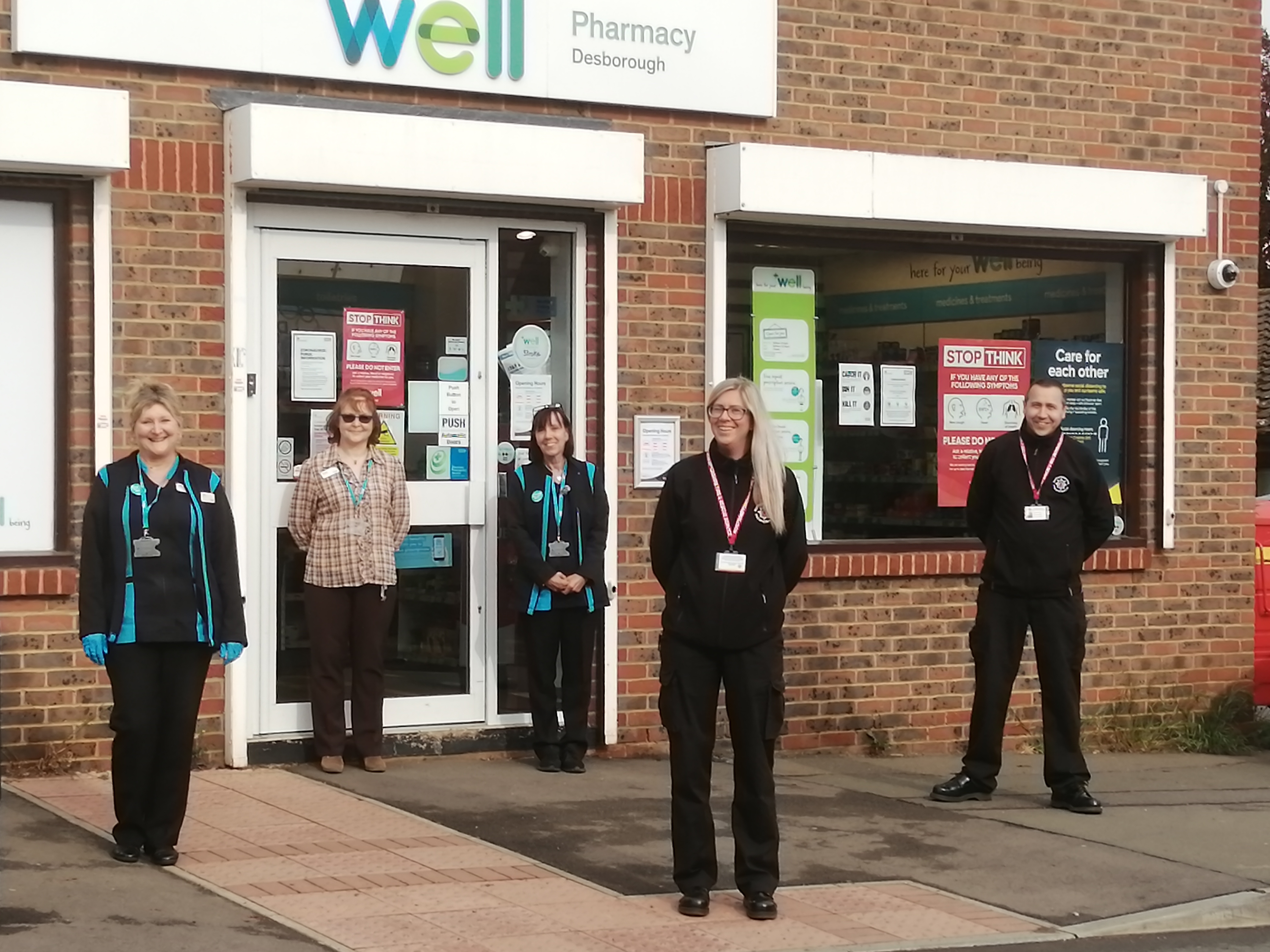 Pharmacy staff in Desborough with two of the on-call firefighters