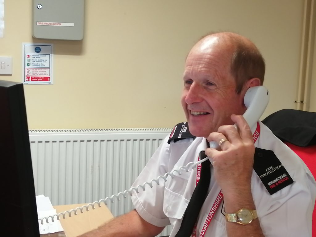 Fire Protection Officer giving advice over the phone
