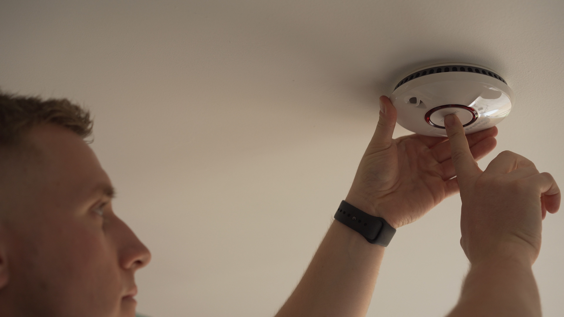 Firefighter checking a smoke alarm