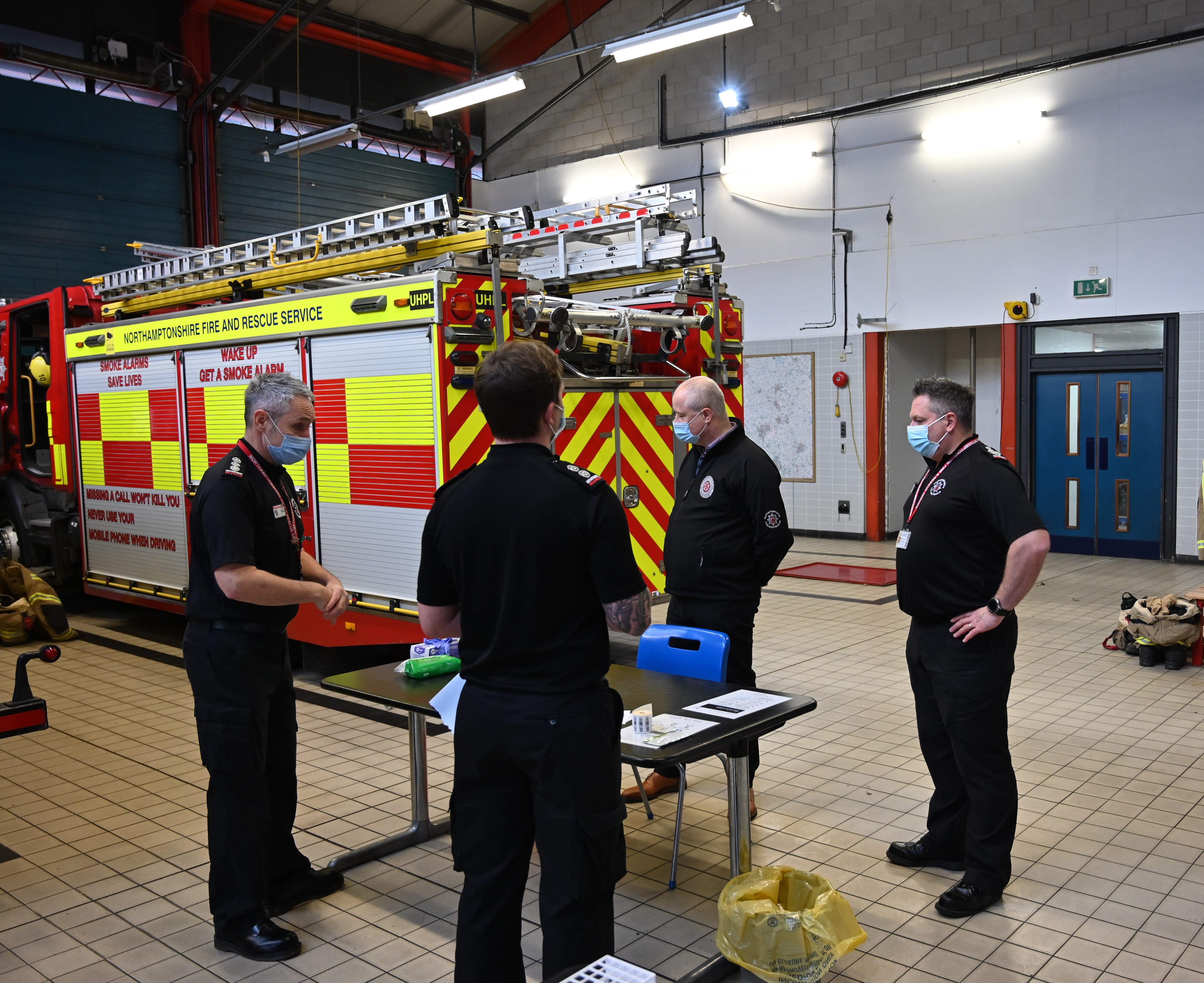 Firefighters conducting lateral flow testing