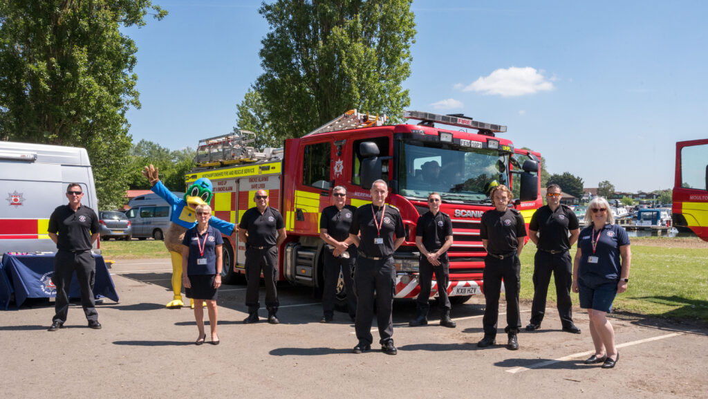 Firefighters and staff in from of appliance at an event at Billing Aquadrome