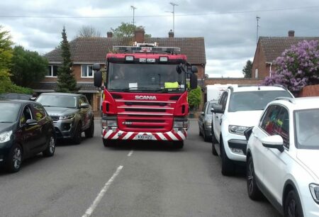 Fire appliance driving down a residential street