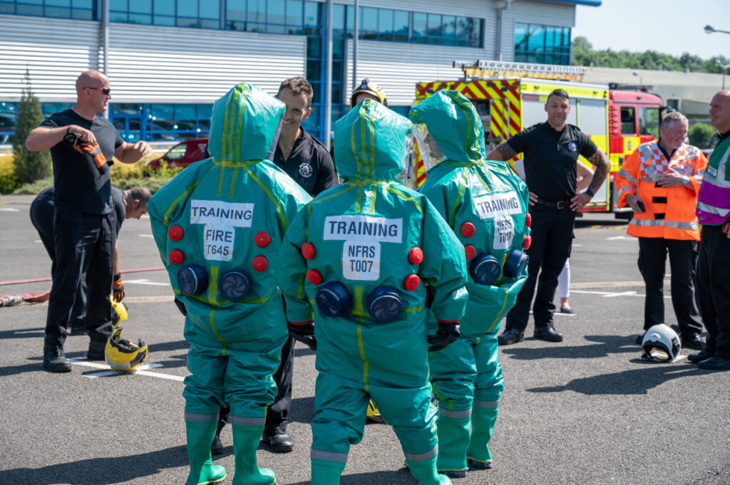 Fire colleagues undertaking a training exercise in decontamination suits