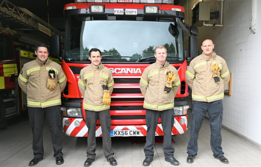 Crew members from Moulton Fire Station in front of fire appliance