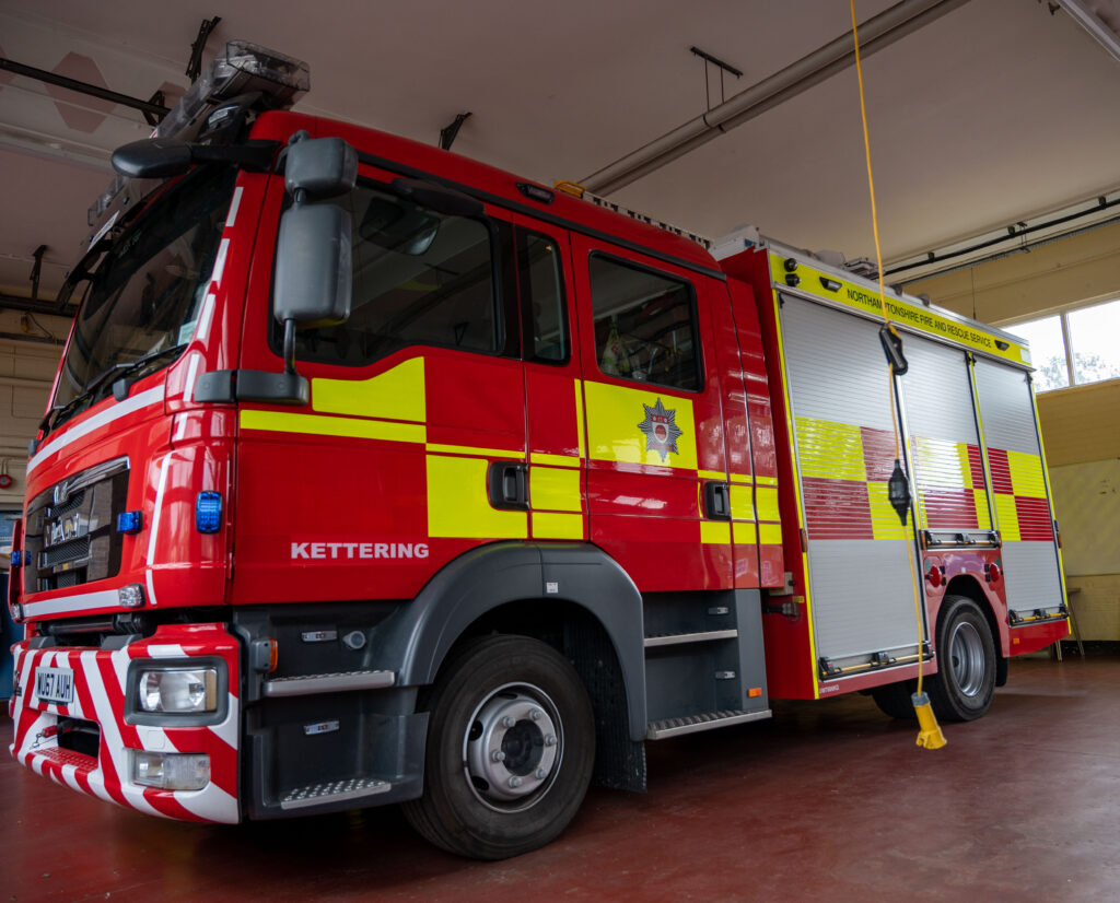 Side view of fire appliance parked inside Kettering Fire Station