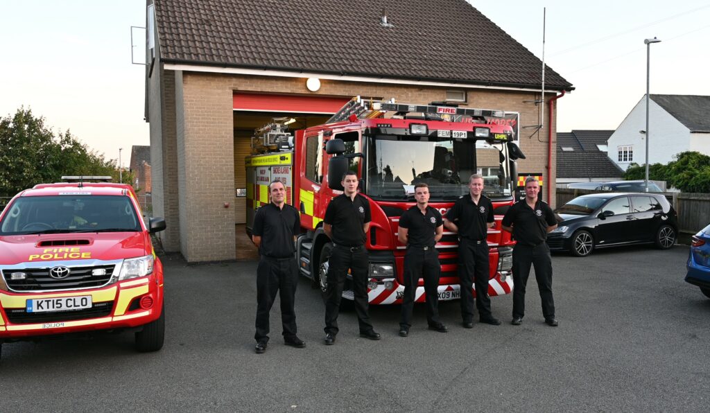 Crew from Earls Barton Fire Station in front of fire appliance