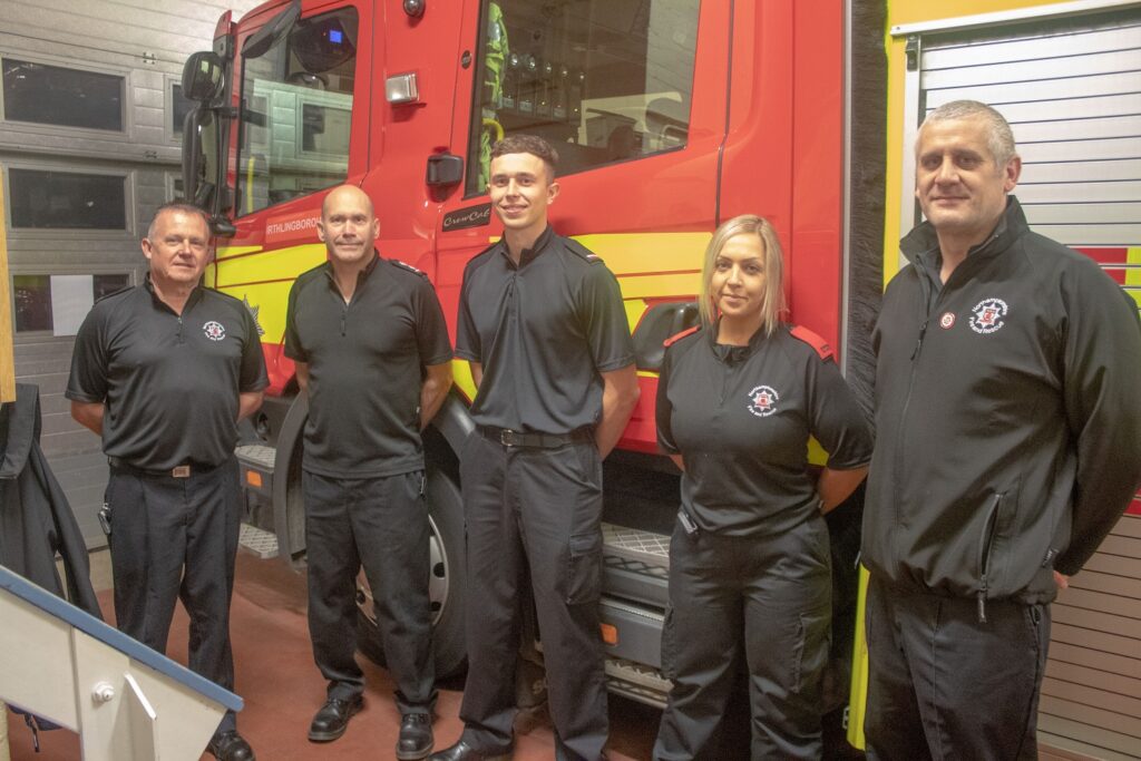 Crew members from Irthlingborough Fire Station by fire appliance