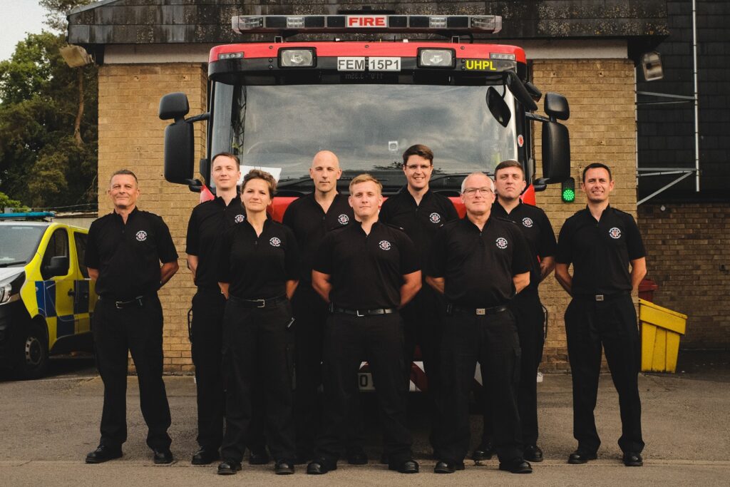 Crew members from Thrapston Fire Station in front of fire appliance