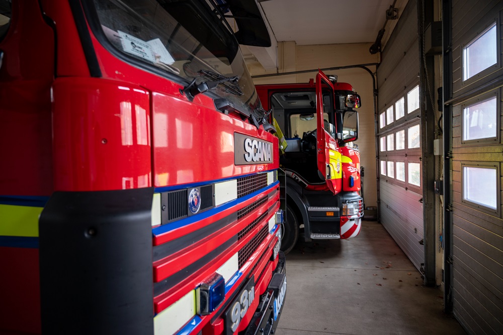 Close up side view of front of two fire appliances