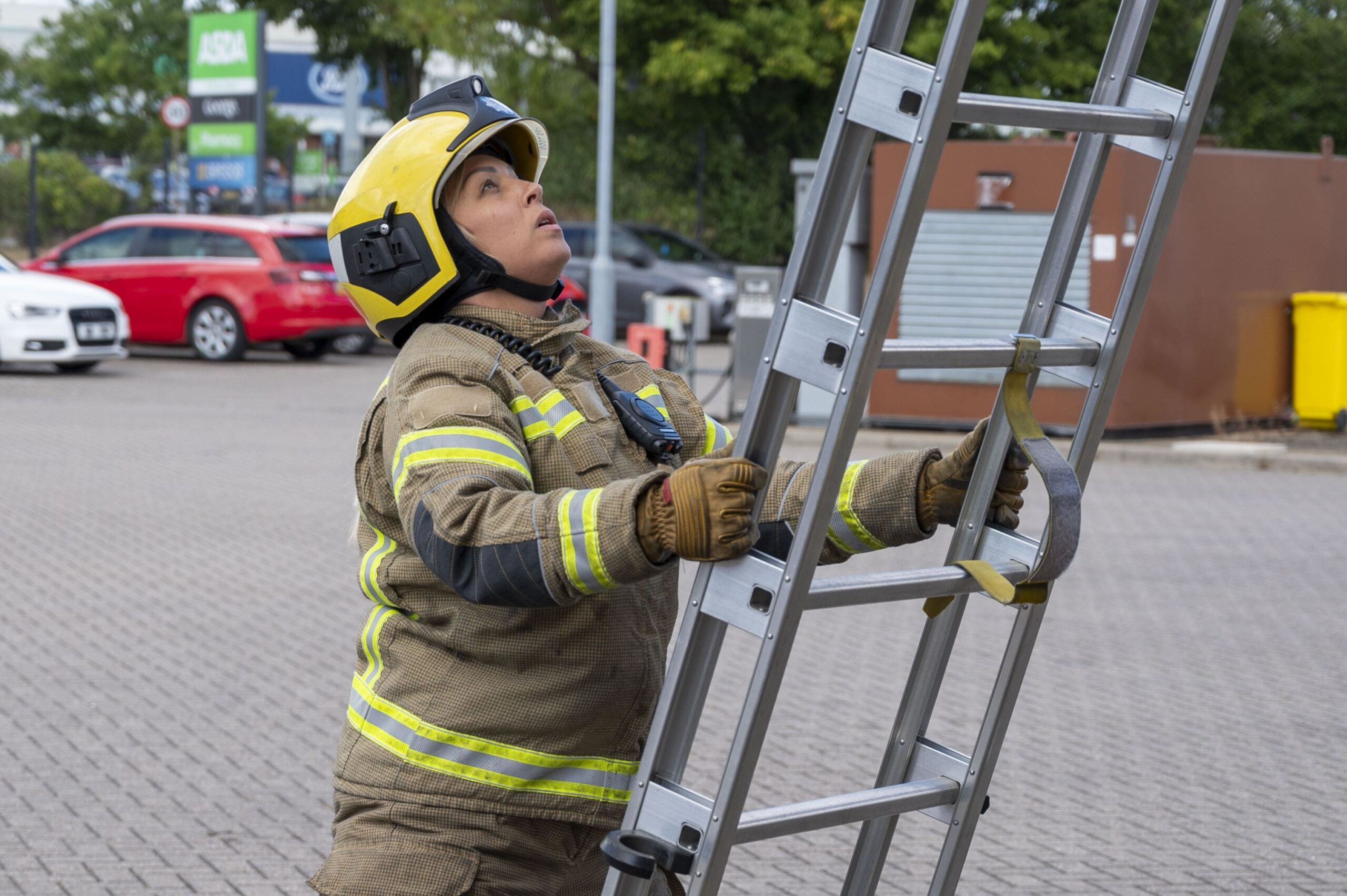 Firefighter supporting ladder