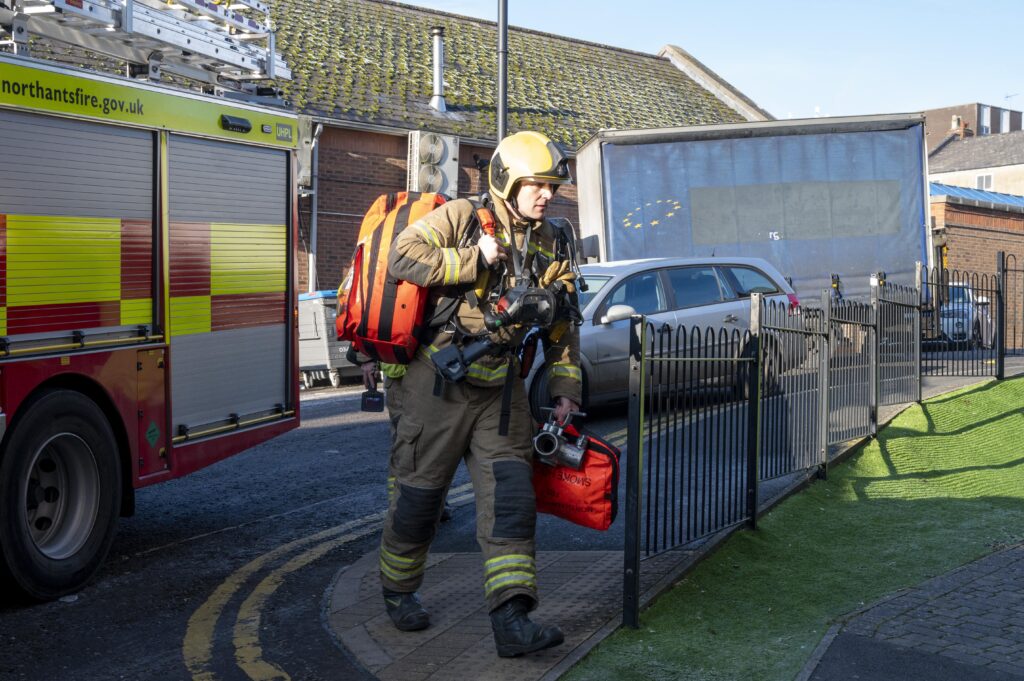 A firefighter prepares to enter The Pinnacle building during an operational exercise