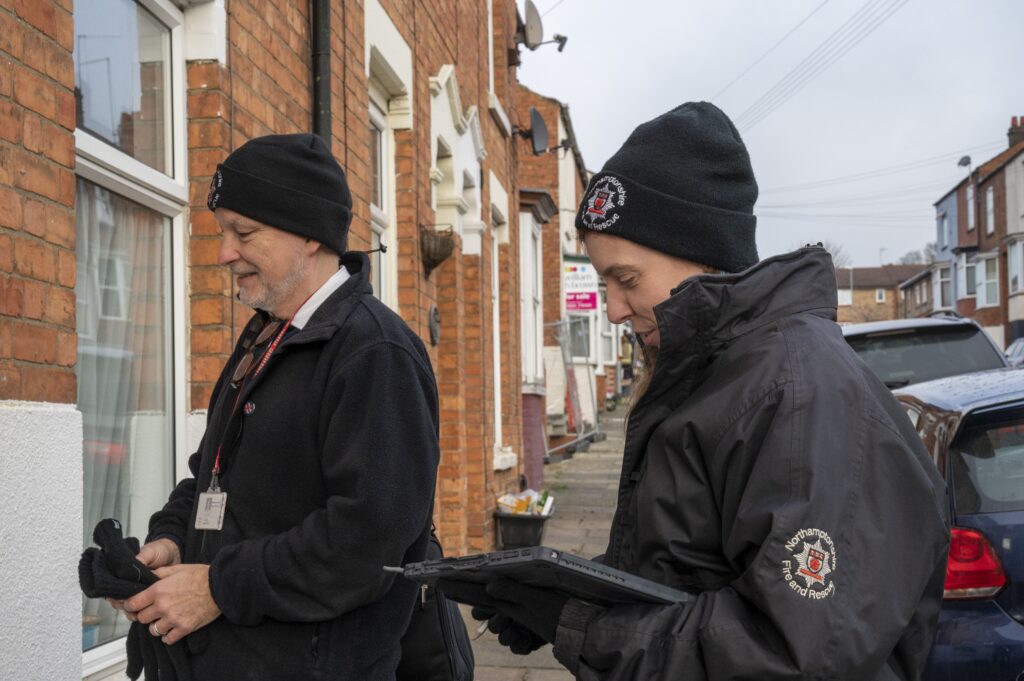 Protection Officers with Northamptonshire Fire and Rescue Service give home safety advise to a HMO owner in Northampton