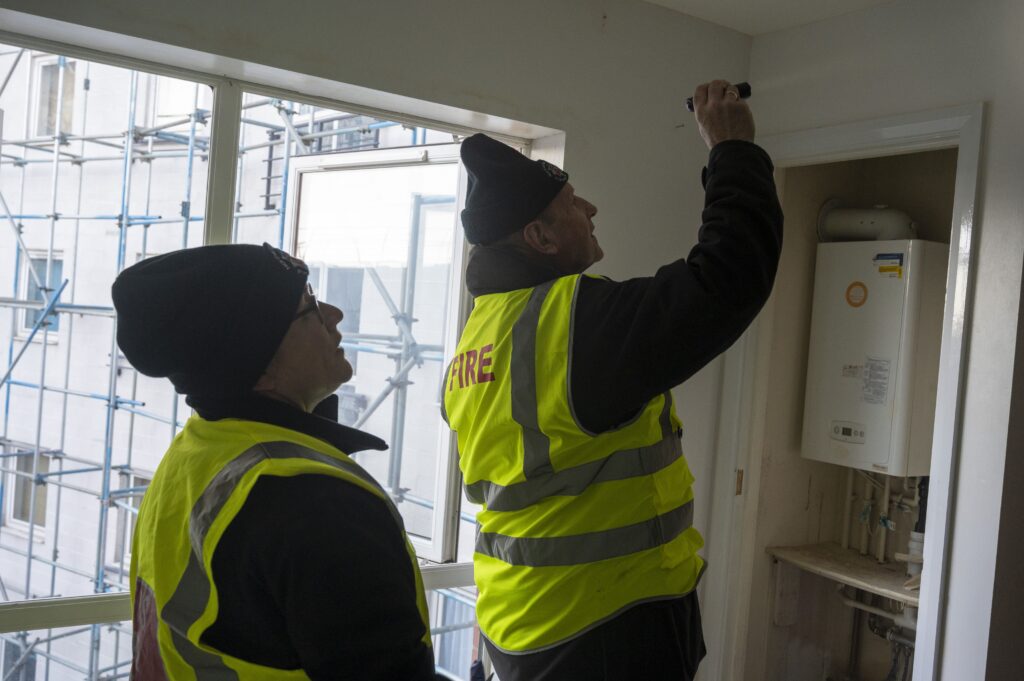 Protection officers from Northamptonshire Fire and Rescue Service inspect the safety of a kitchen during a training exercise