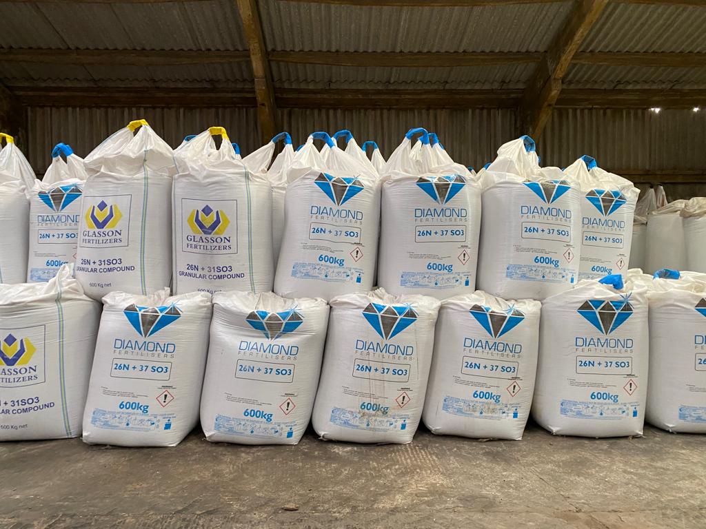 Sacks of fertilizer being stored in a barn