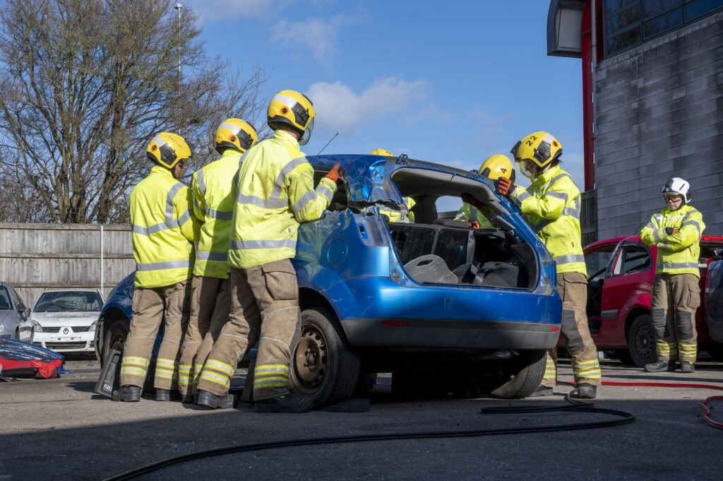 A group of firefighters carrying the roof of a car during an RTC drill.