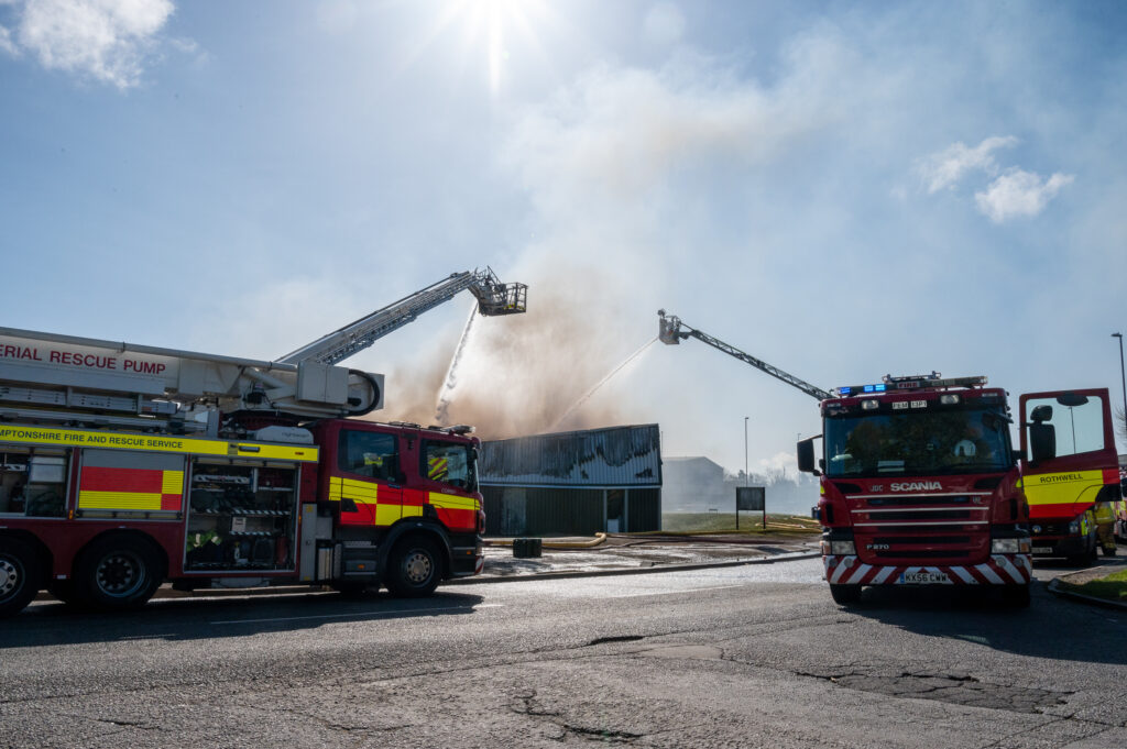 Fire engines spray water over a building that had caught fire at the Earlstrees Industrial Estate in Corby