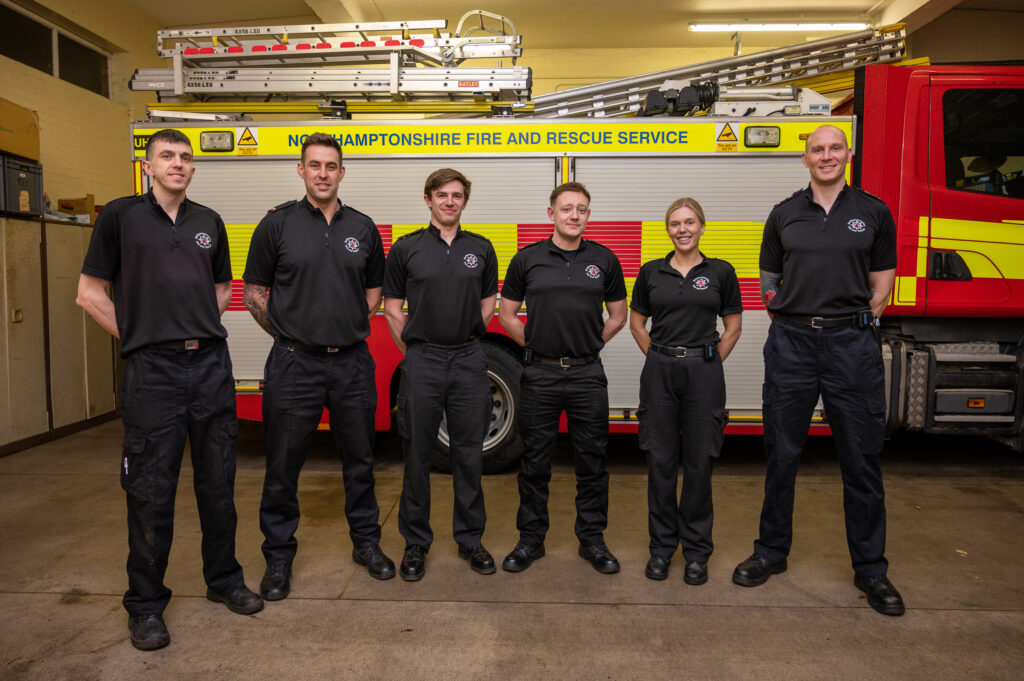 Towcester On Call Crew stood with side of a fire engine at Towcester Fire Station