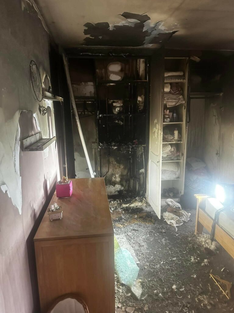 The charred remains of a desk, bookcase and other furniture in the bedroom of a Wellingborough home that was struck by lightning.