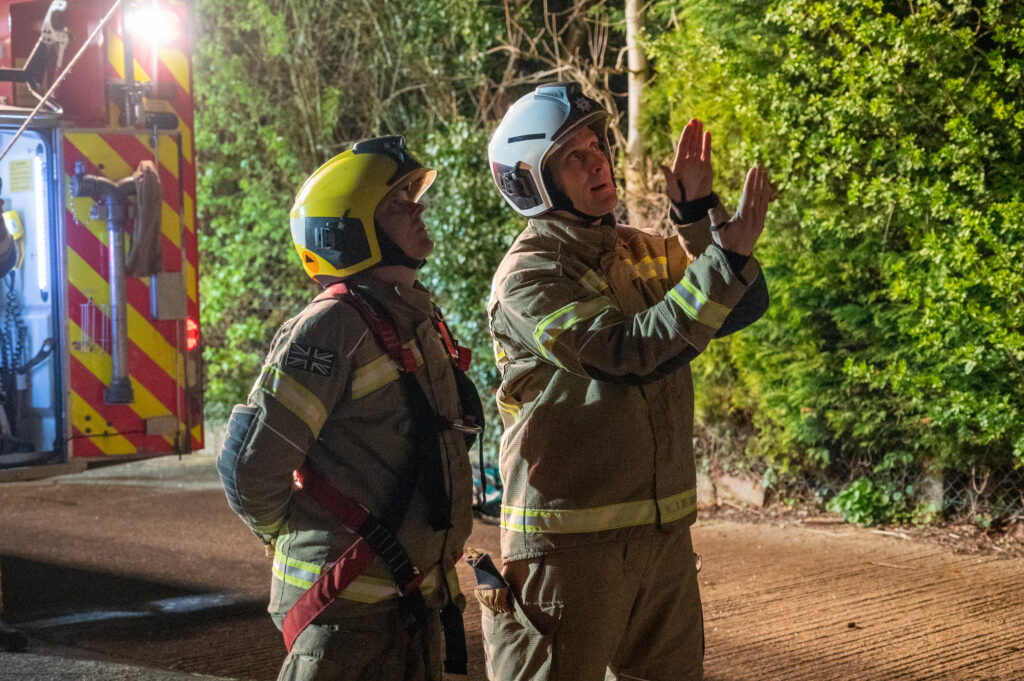 Two Brixworth firefighters discussing an ongoing drill 