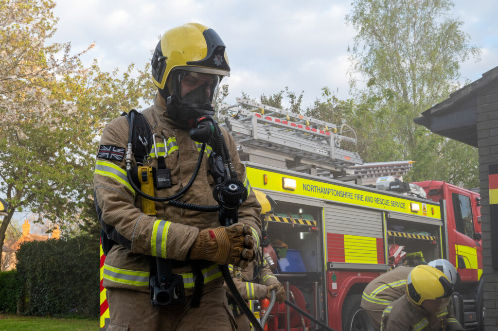 Firefighter in full BA entering a building