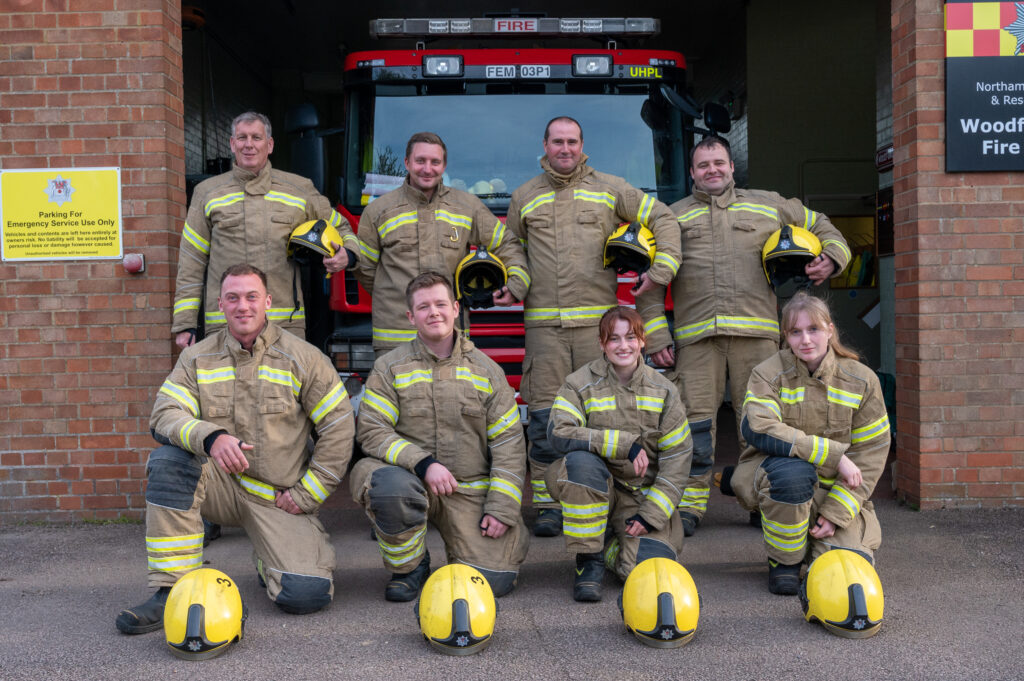 Thw Woodford Halse fire crew, consisting of 8 firefighters standing in front of their fire engine