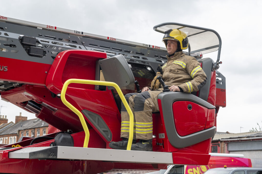 A firefighter on a fire engine 