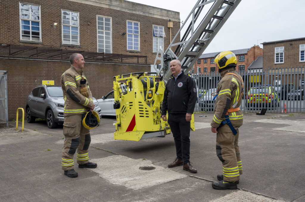 PFCC Stephen Mold talking to two firefighters 