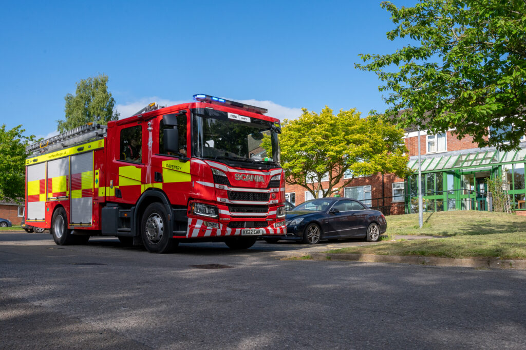 The Daventry fire engine is shown parked up outside a sheltered housing building in Long Buckby, where there were called to deal with an incident.