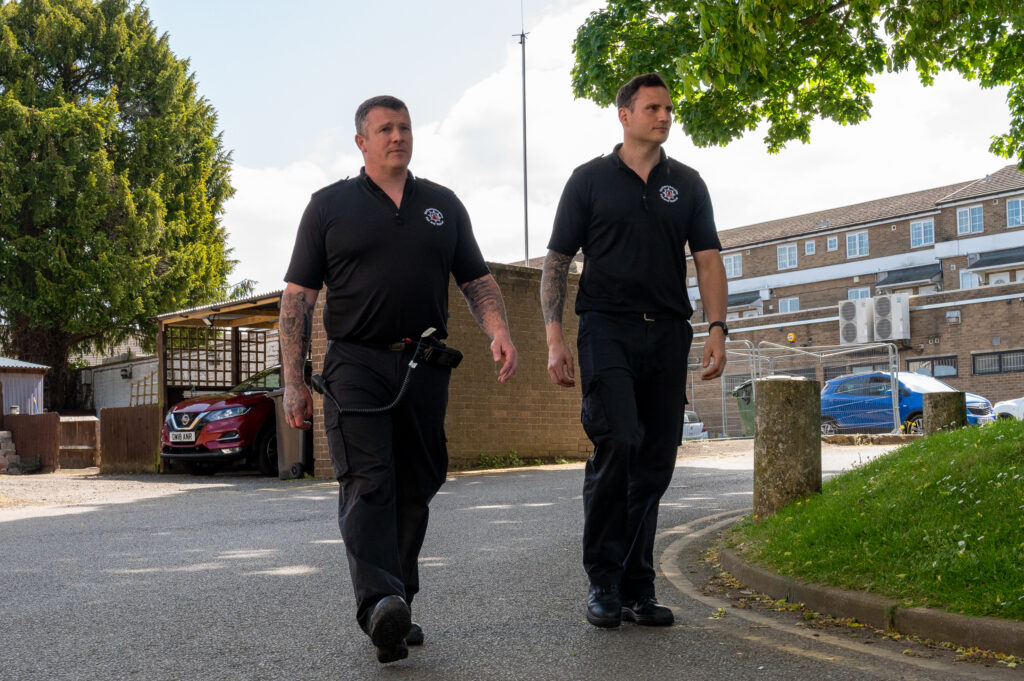 Watch Manager Duncan Timbs (left) and firefighter Sebastian Ward (right) pictured walking to meet the Town Ranger in Daventry