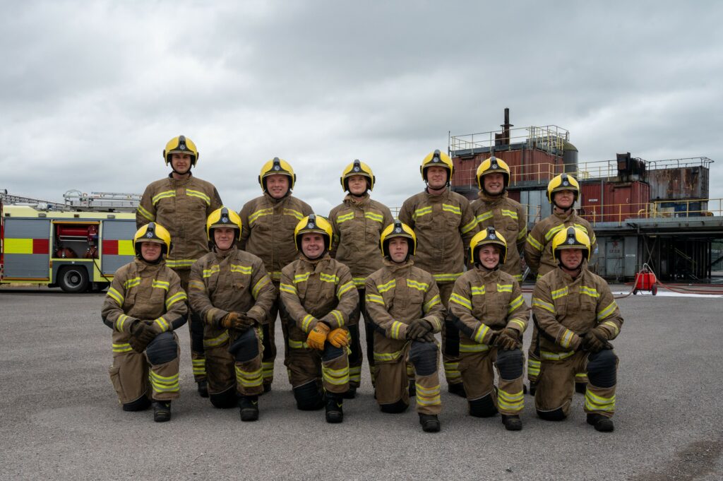 The 12 new Northamptonshire Fire apprentices, in their fire tunics, are pictured at the Fire Service College.