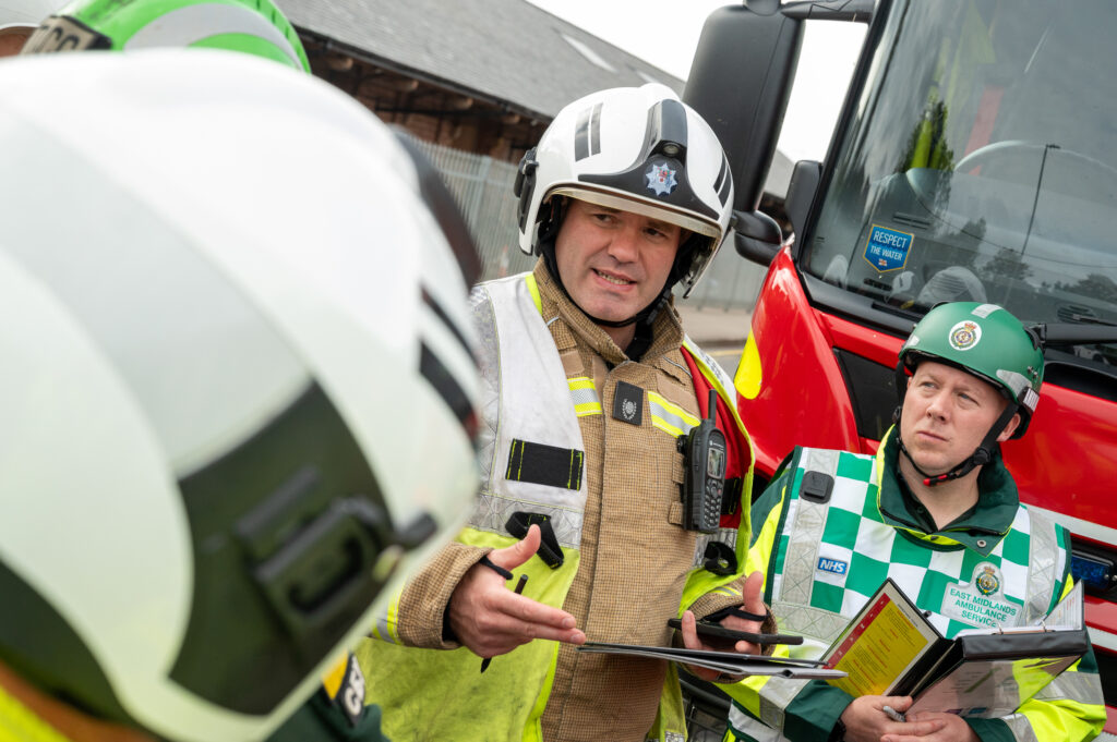 A firefighter talking during a multi-agency meeting