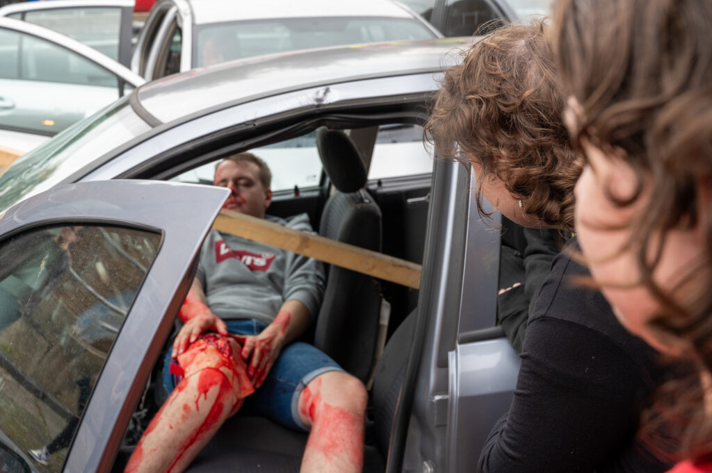 Two members of the GAINN project looking in to a car that has been involved in a mock RTC