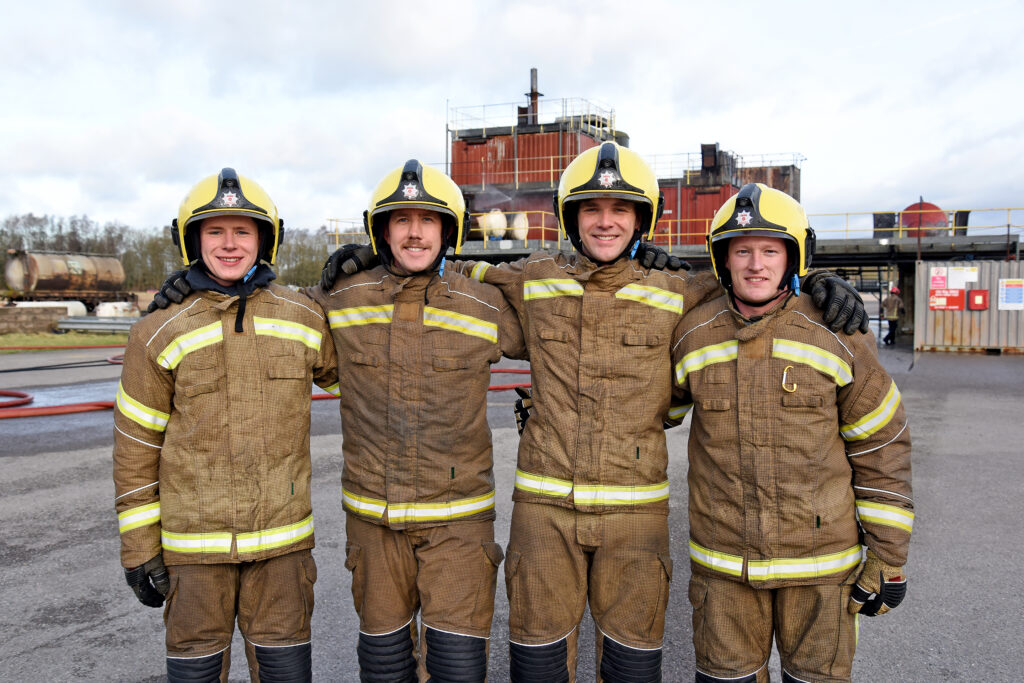The four new recruits stood arm in arm on the drill yard at the Fire Service College