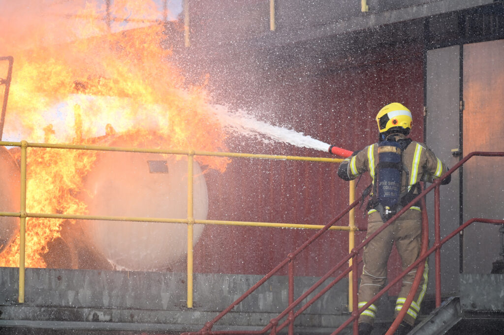 A firefighter tackling a large blaze