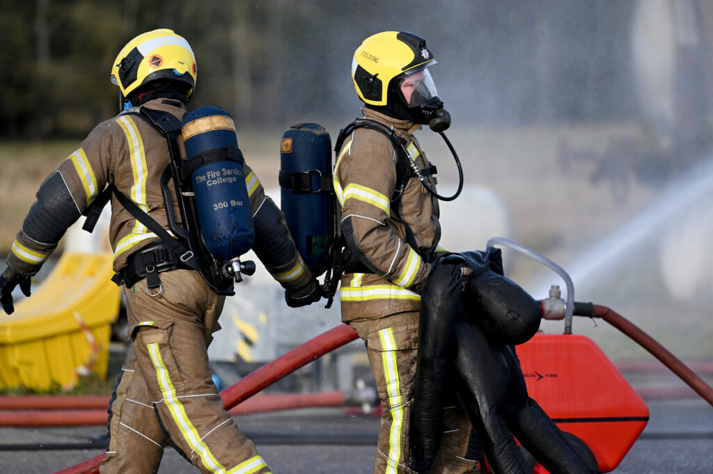 Two firefighters rescuing a dummy.