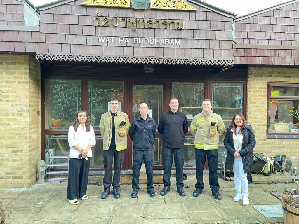 Pictured outside the Wat Pa Buddharam are members of the Rushden fire crew, flanked by Temple leaders