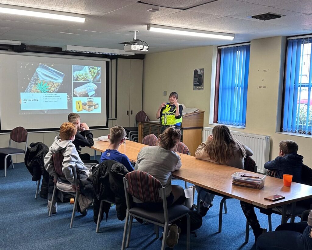 A classroom lecture led by a police officer