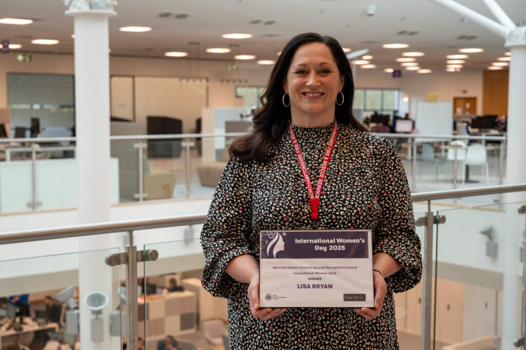 Lisa Bryan is pictured holding her Inspirational Woman certificate.