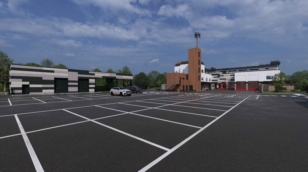 A computer generated image shows an artist's impression of the back of the new Moulton Fire Station. There are a number of car parking space (grey) as well as the exterior of the building in the background.