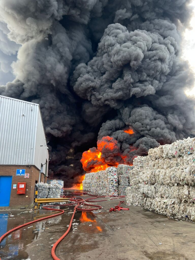 Large fire, black plume of smoke